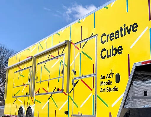 Yellow trailer that says Creative Cube Mobile Art Studio